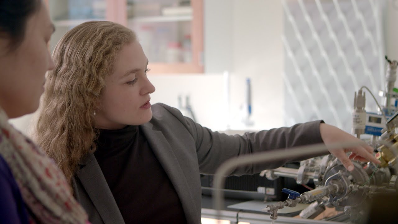 V. Faye McNeill pointing at research instruments on the right