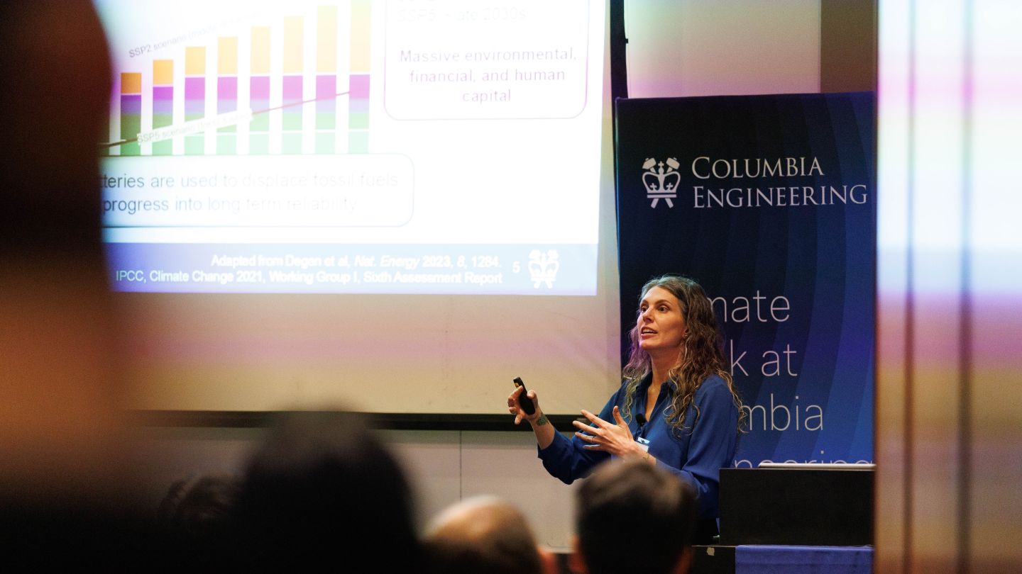 Lauren Marbella delivering a presentation while gesturing in front of a projected slide at Columbia Engineering.