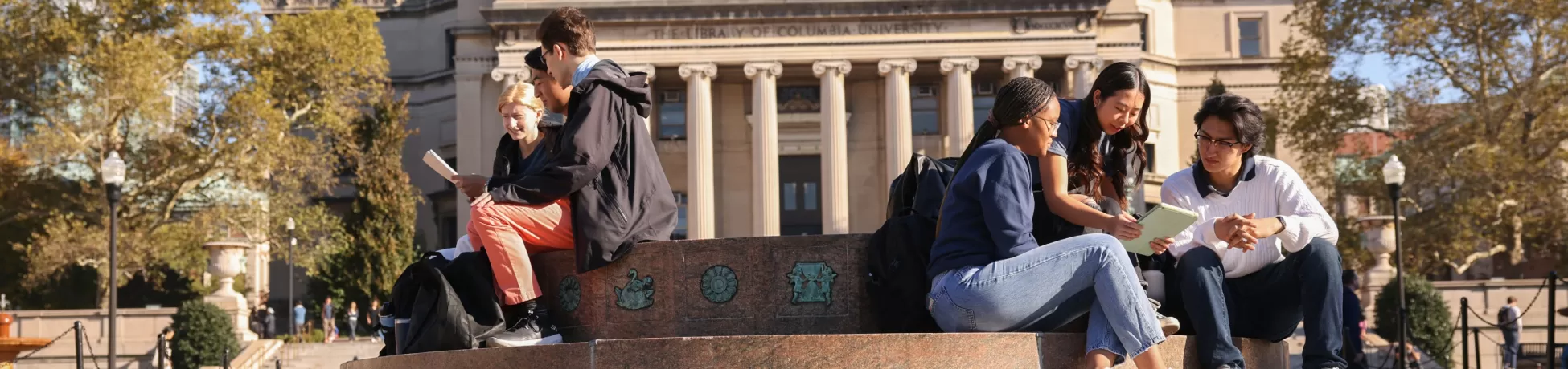 Columbia Engineering students sit beside a fountain in the quad at Columbia University