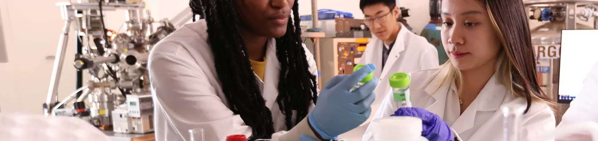 two female students working together in a lab (photo by John Abbott)