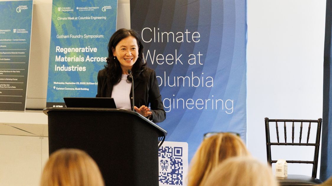 Helen Lu speaking to an audience from a podium at the Gotham Foundry symposium.